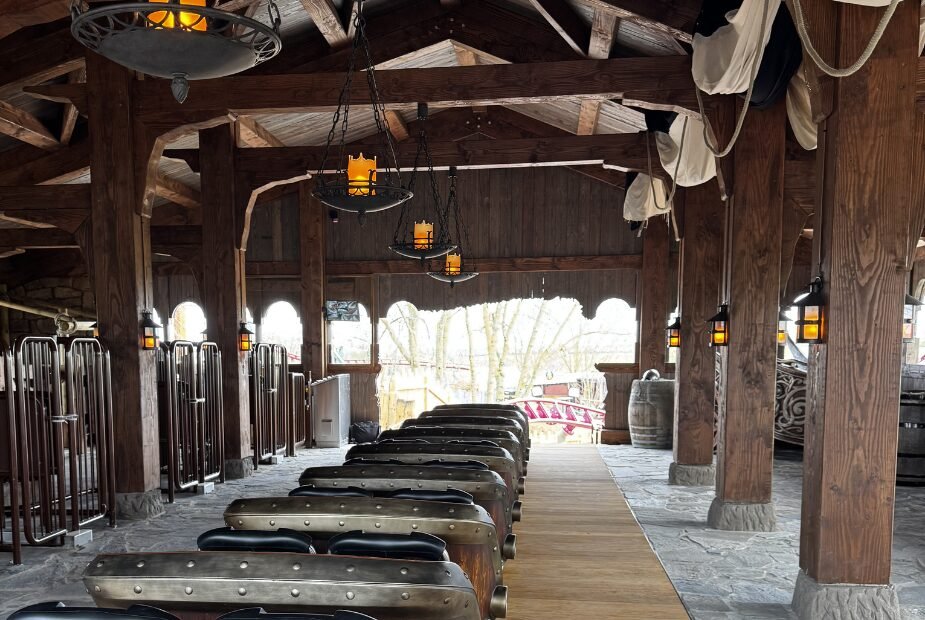 Valkyrie coaster train inside a timber station with themed lanterns at Festyland.