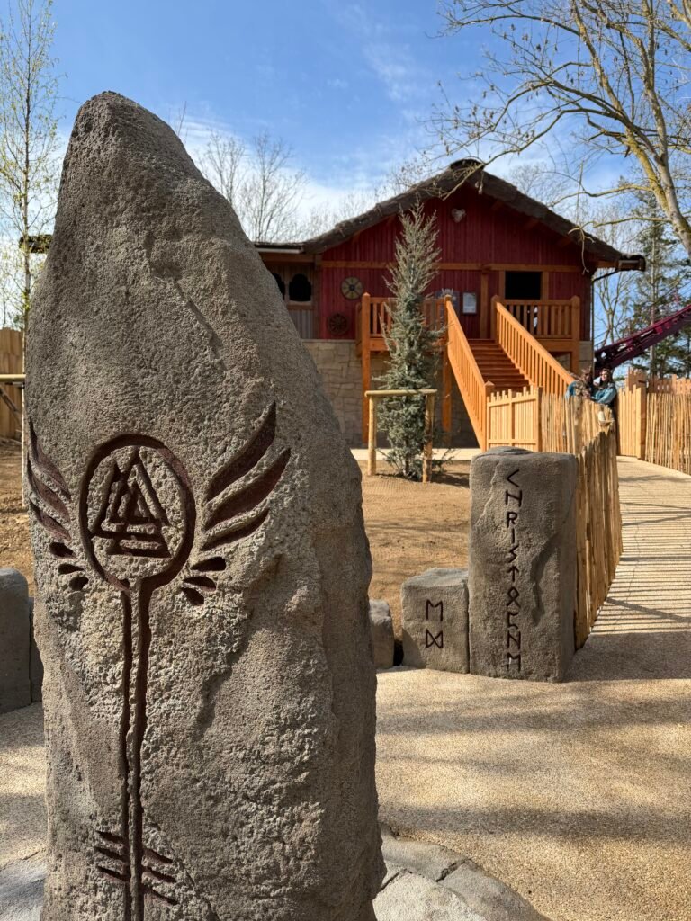 Carved Viking-style standing stones beside the Valkyrie attraction at Festyland.